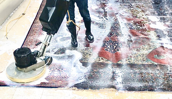 Area rug cleaning using an equipment